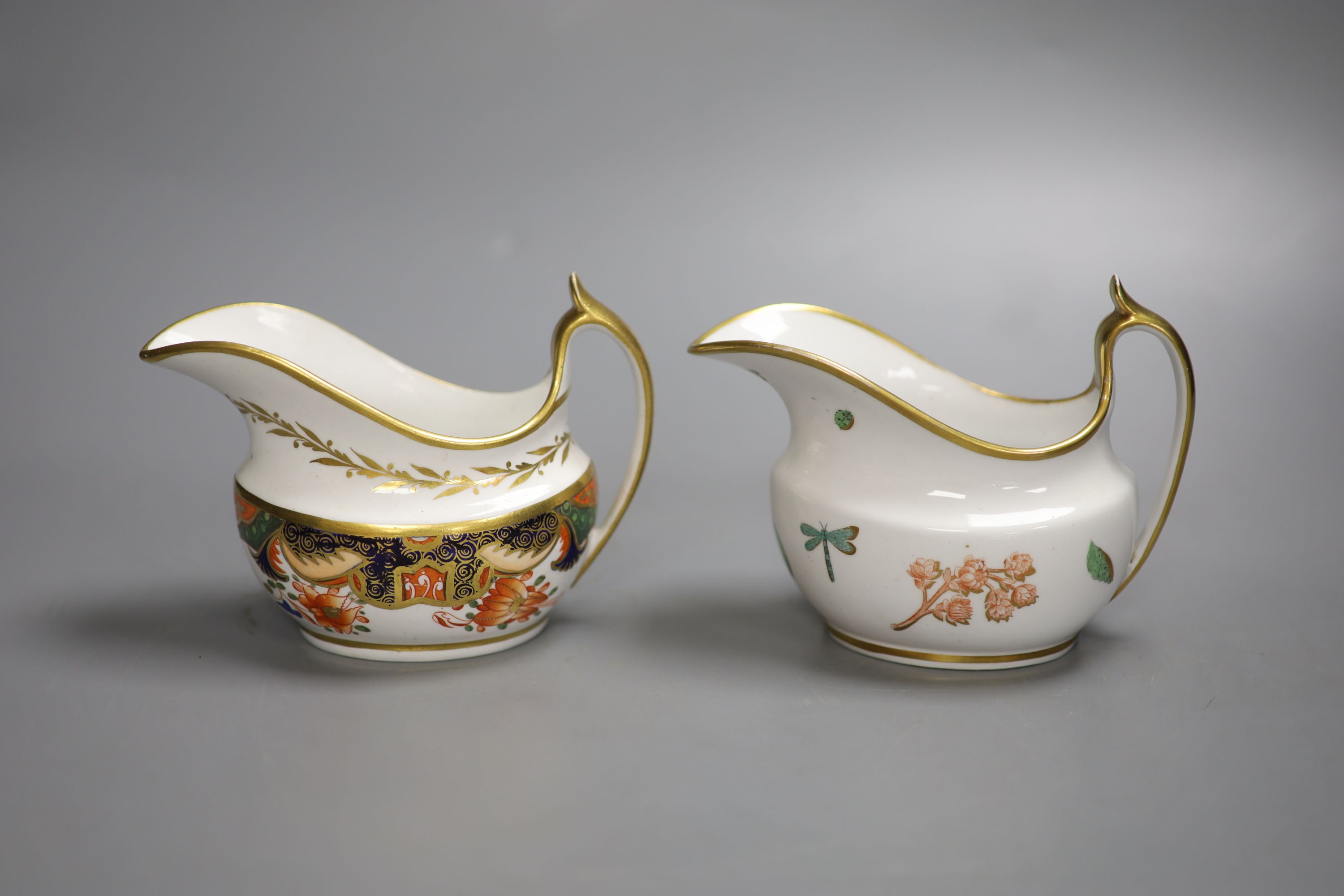 A Spode cream jug painted with Imari pattern 1645 and a Spode cream jug painted with flowers and insects pattern 1025, tallest 10cm